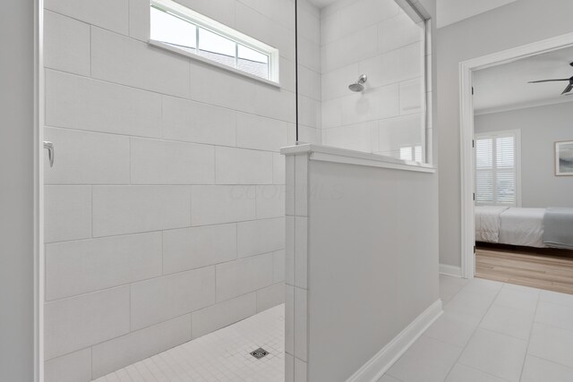 full bath with baseboards, a walk in shower, ceiling fan, and ensuite bath