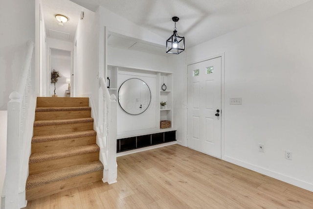 mudroom featuring light wood finished floors and baseboards