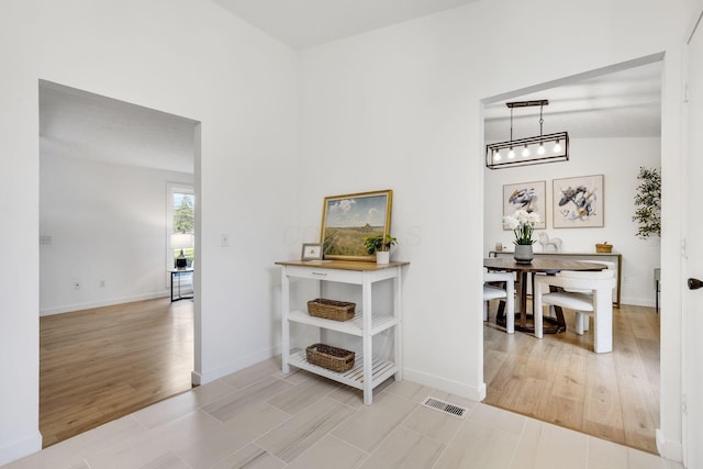 hall with wood finished floors and baseboards