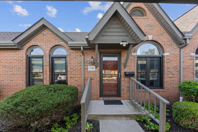 5796 Thada Ln, Columbus, OH 43229 - property entrance with a shingled roof and brick siding