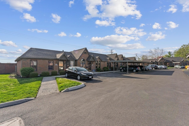 5796 Thada Ln, Columbus, OH 43229 - view of building exterior with covered and uncovered parking and a residential view