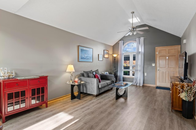 5796 Thada Ln, Columbus, OH 43229 - living area featuring lofted ceiling, baseboards, a ceiling fan, and wood finished floors
