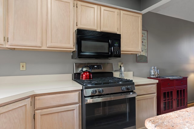 5796 Thada Ln, Columbus, OH 43229 - kitchen featuring light countertops, stainless steel range with gas cooktop, black microwave, and light brown cabinets