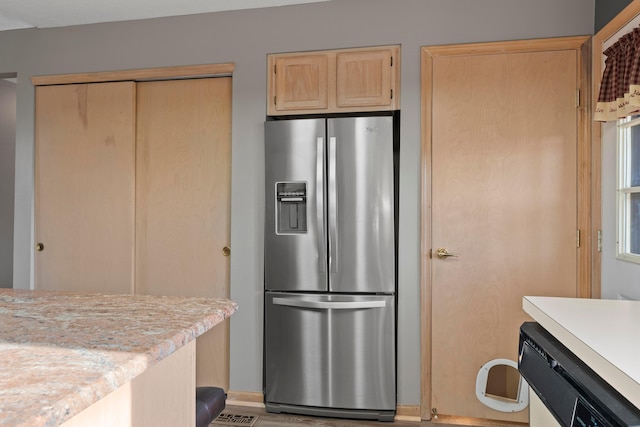 5796 Thada Ln, Columbus, OH 43229 - kitchen with light countertops, light brown cabinetry, dishwashing machine, and stainless steel fridge with ice dispenser
