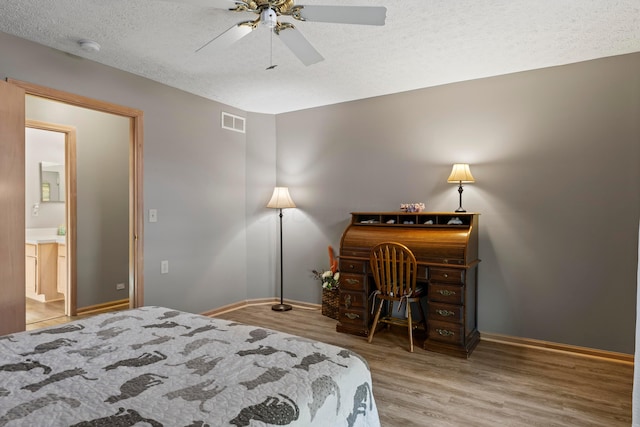 5796 Thada Ln, Columbus, OH 43229 - bedroom with baseboards, wood finished floors, visible vents, and a textured ceiling