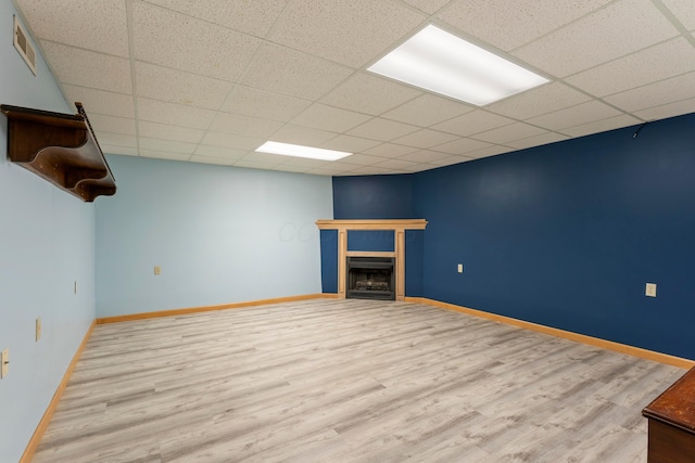 5796 Thada Ln, Columbus, OH 43229 - basement featuring wood finished floors, visible vents, baseboards, a fireplace, and a paneled ceiling