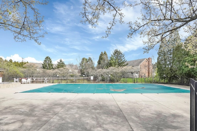 view of swimming pool featuring fence, a fenced in pool, and a patio