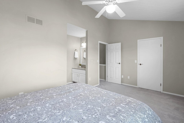 unfurnished bedroom with ensuite bathroom, baseboards, visible vents, carpet, and high vaulted ceiling