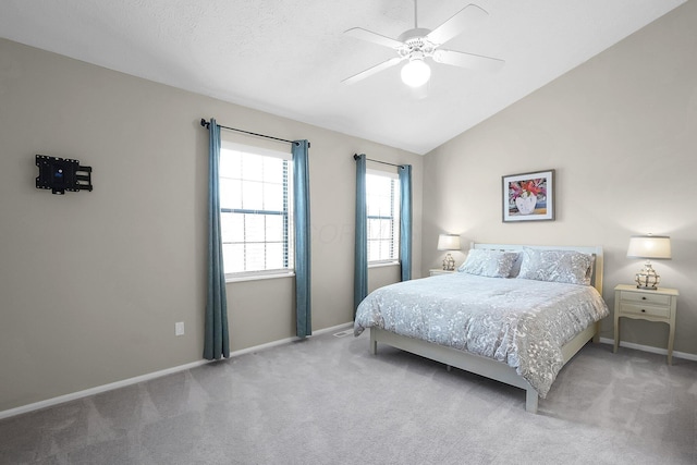 bedroom featuring lofted ceiling, baseboards, carpet floors, and ceiling fan