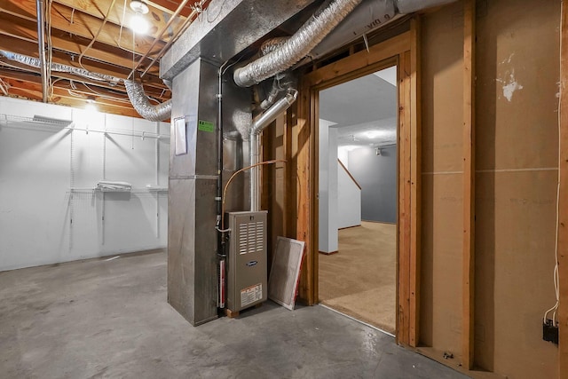 unfinished basement featuring heating unit