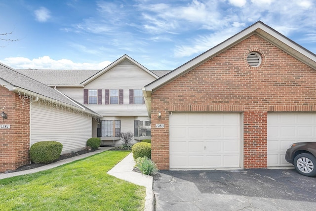 view of front of house featuring an attached garage, brick siding, aphalt driveway, and a shingled roof