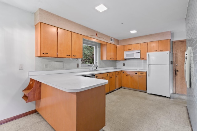 kitchen with a sink, white appliances, light countertops, a peninsula, and visible vents