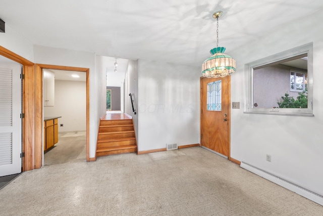 foyer entrance with visible vents, light carpet, baseboards, stairway, and a baseboard heating unit