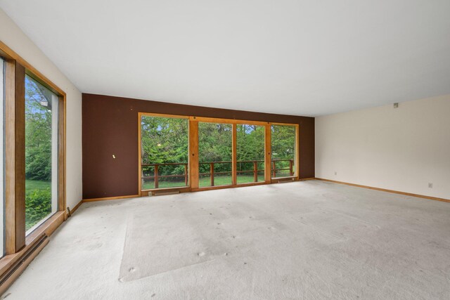 unfurnished room featuring carpet flooring and baseboards