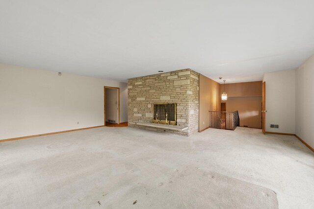 unfurnished living room featuring carpet floors, baseboards, visible vents, and a fireplace