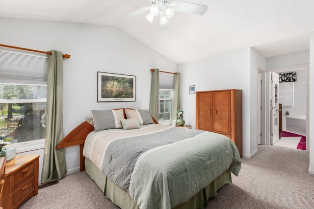 bedroom featuring a ceiling fan, vaulted ceiling, light carpet, and multiple windows