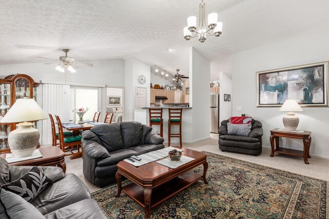 living area with light carpet, ceiling fan with notable chandelier, a textured ceiling, and lofted ceiling