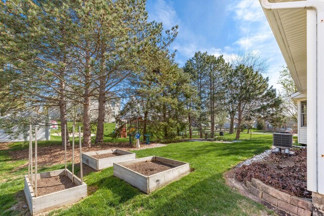 view of yard featuring central AC unit and a garden