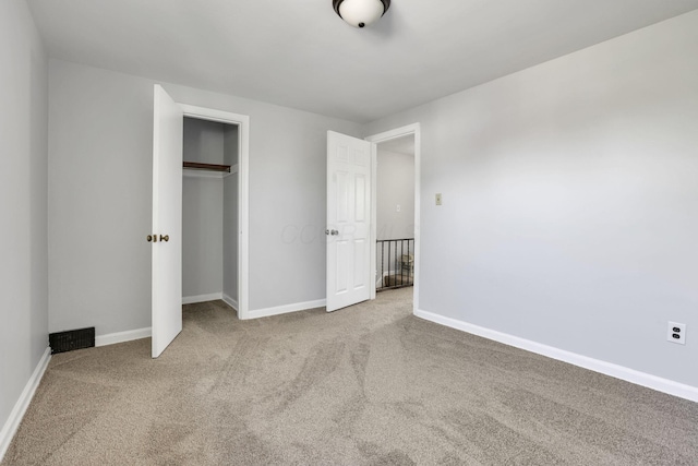 unfurnished bedroom featuring a closet, carpet, and baseboards