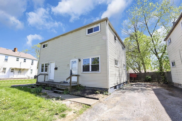 view of front of home with a front lawn and fence