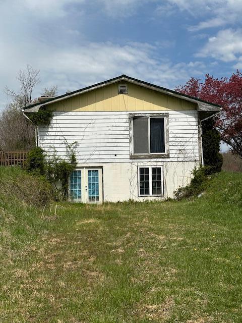 view of home's exterior featuring fence and a yard