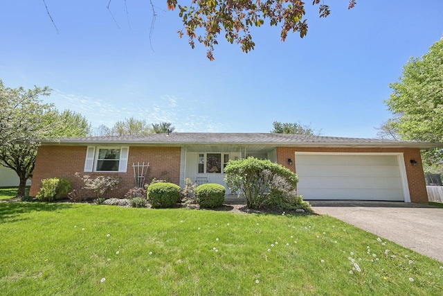 ranch-style house with a garage, brick siding, driveway, and a front yard
