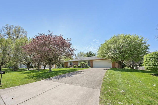 view of front of home featuring a front lawn, driveway, and an attached garage