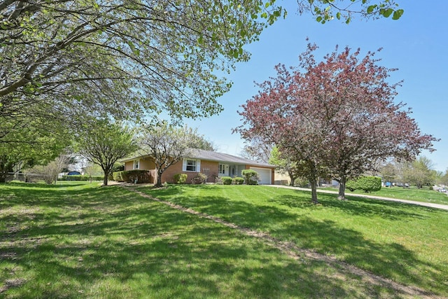 view of front of property with a front yard and a garage