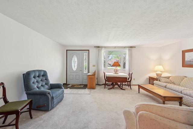 living area featuring a textured ceiling and light colored carpet