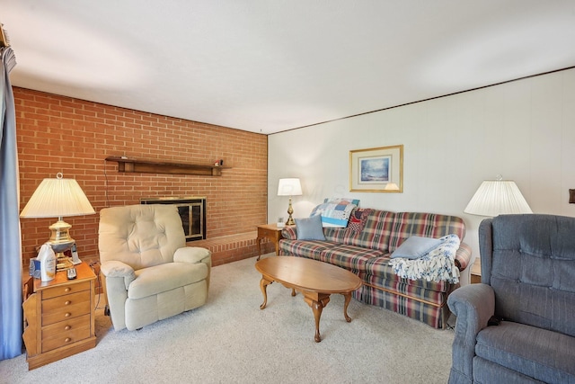 carpeted living room with brick wall and a brick fireplace