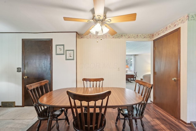 dining area featuring a ceiling fan, visible vents, and wood finished floors