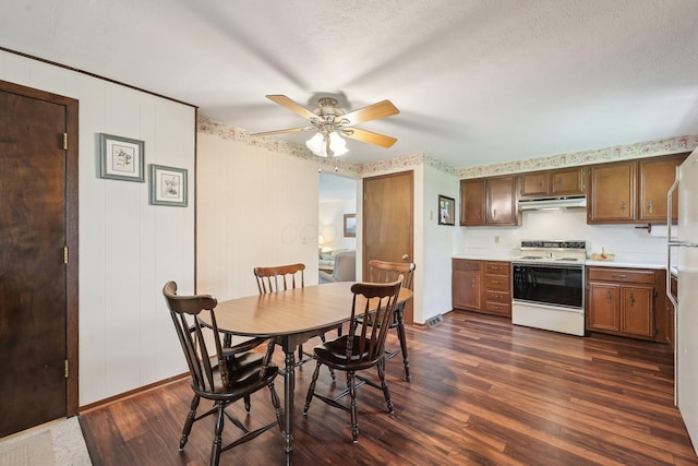 dining area featuring dark wood-style flooring, a ceiling fan, and baseboards