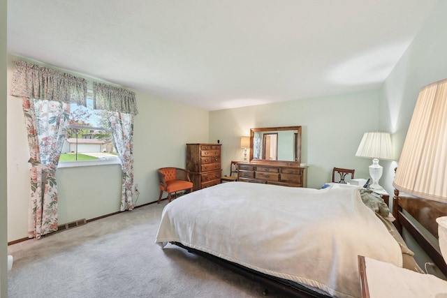 bedroom featuring baseboards, visible vents, and carpet flooring