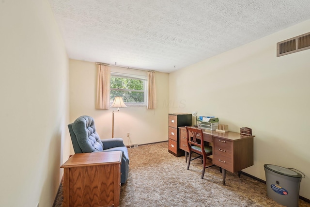 carpeted office space featuring baseboards, visible vents, and a textured ceiling