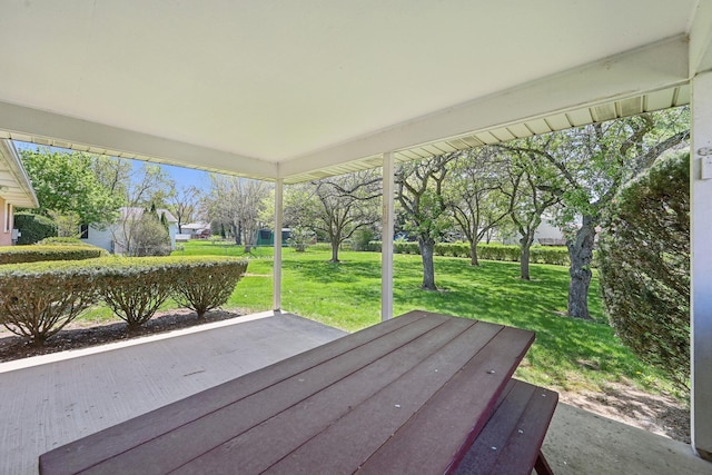 wooden deck with a lawn and a patio area