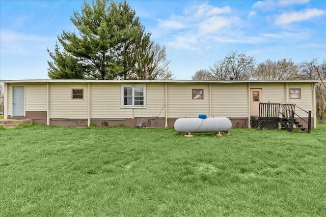 rear view of property featuring a yard