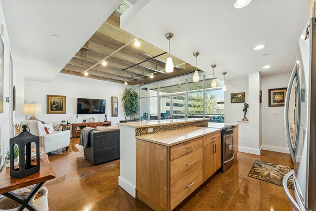 kitchen featuring baseboards, open floor plan, appliances with stainless steel finishes, and finished concrete floors