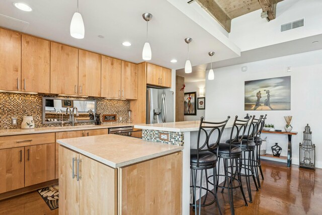kitchen with stainless steel appliances, light countertops, a kitchen island, backsplash, and visible vents