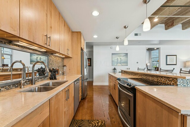 kitchen featuring decorative backsplash, a sink, appliances with stainless steel finishes, visible vents, and baseboards