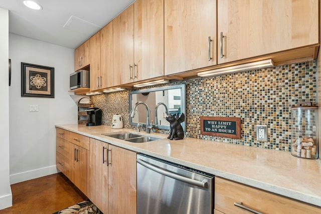 kitchen featuring a sink, appliances with stainless steel finishes, baseboards, light brown cabinetry, and backsplash