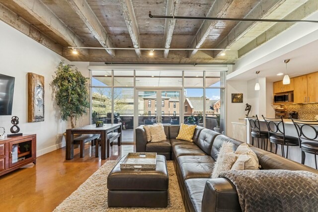 living area with finished concrete flooring and baseboards