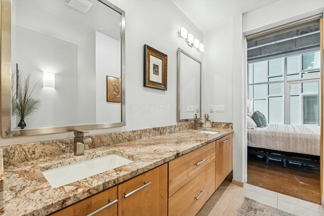 full bathroom featuring tile patterned floors, visible vents, double vanity, and a sink