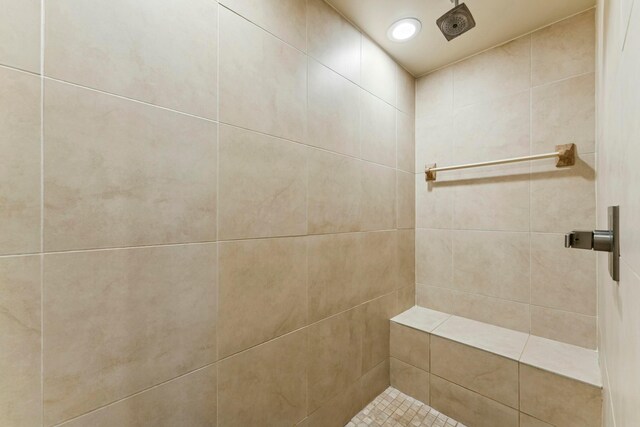 bathroom with tiled shower