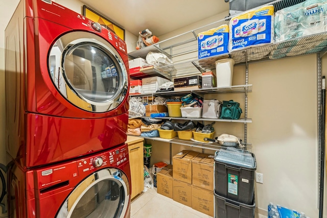 laundry area featuring tile patterned flooring, stacked washer / drying machine, and laundry area