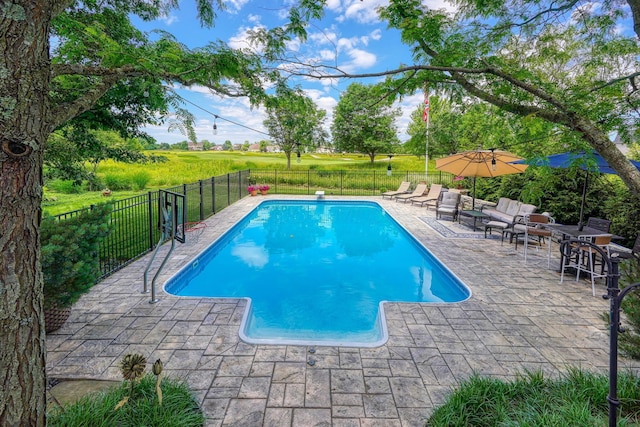view of swimming pool with a patio, fence, and a fenced in pool