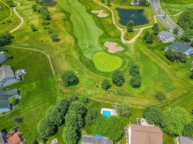 birds eye view of property featuring golf course view and a water view