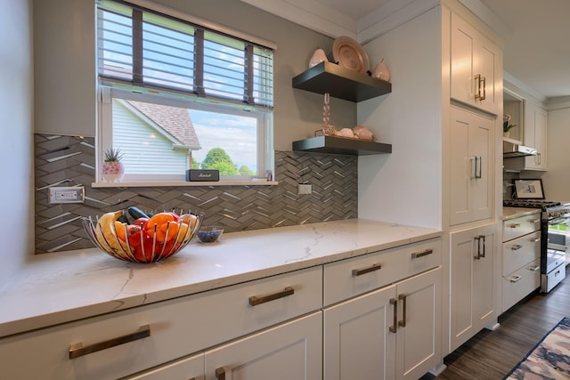 kitchen with tasteful backsplash, open shelves, white cabinets, and gas stove