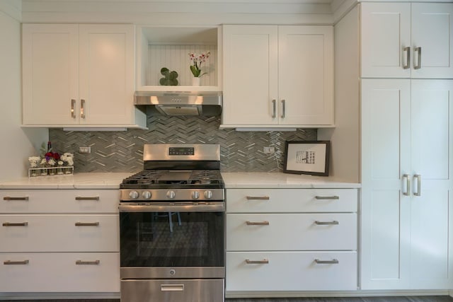 kitchen featuring white cabinetry, tasteful backsplash, under cabinet range hood, and stainless steel range with gas cooktop