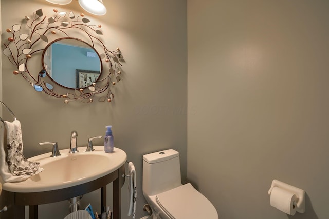 bathroom with toilet and a sink