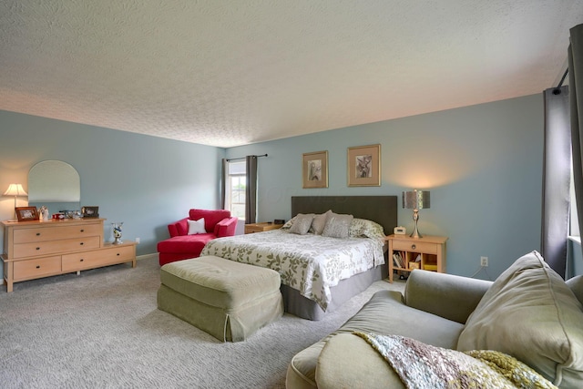 bedroom featuring a textured ceiling and carpet flooring